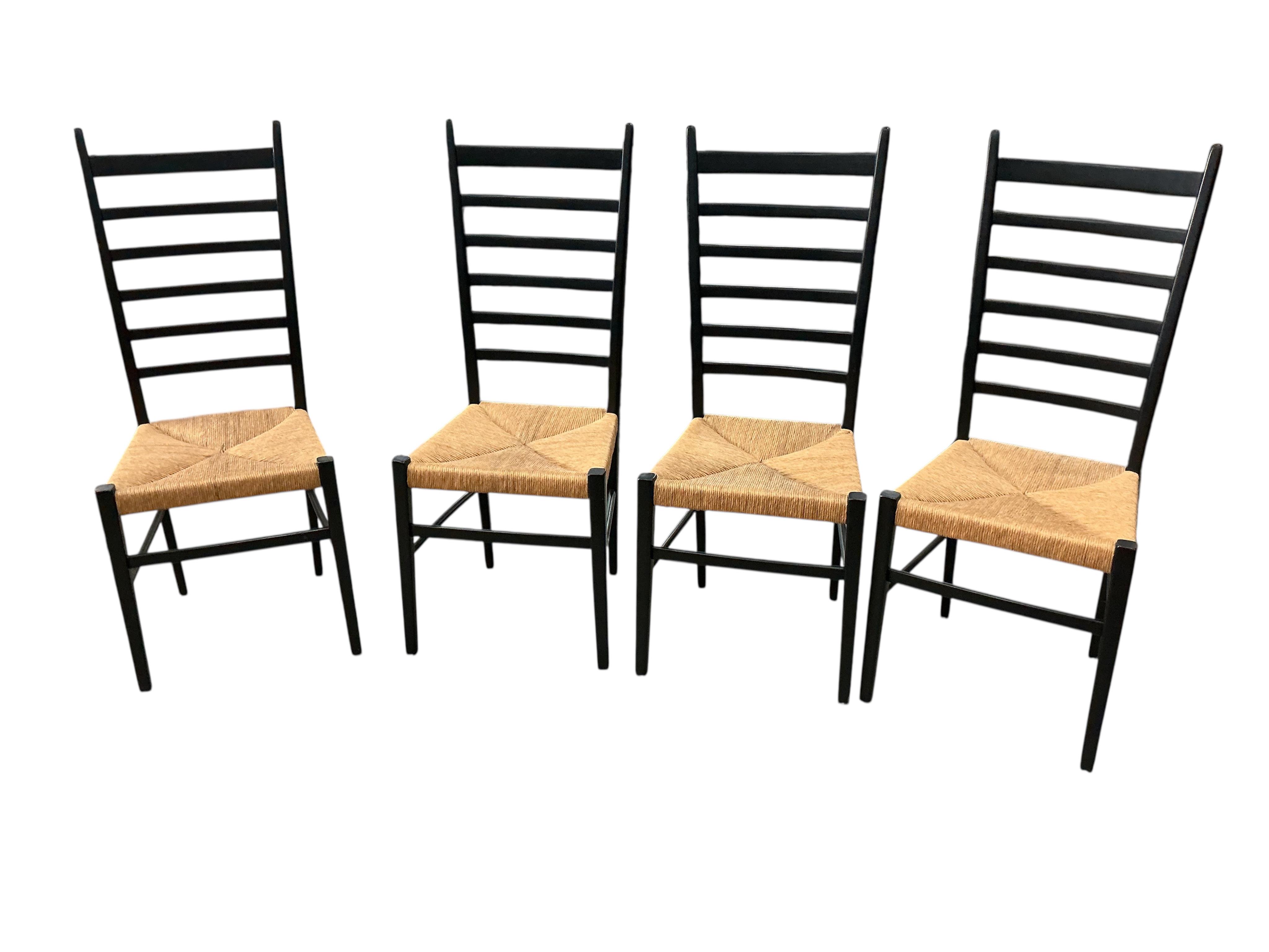 A set of four Gio Ponti ebonised ladderback rush seat dining chairs, width 40cm, depth 41cm, height 107cm